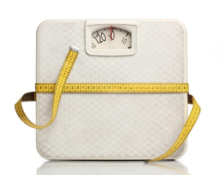 Weight scale with a measuring tape over white