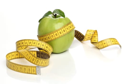 Healthy green apple and a measuring tape isolated