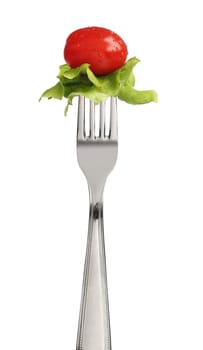 Fork with letucce and tomato over white