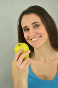 Beautiful young girl is holding an apple