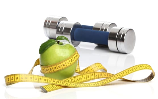 Healthy green apple and a measuring tape isolated