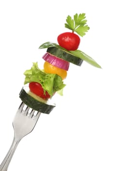 Mixed vegetables on a fork isolated. Diet concept