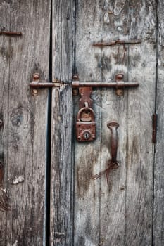 Rusty padlock on an old wooden door of the indian house