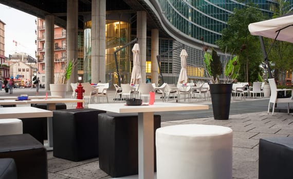 Little tables and stools in a outdoor pub