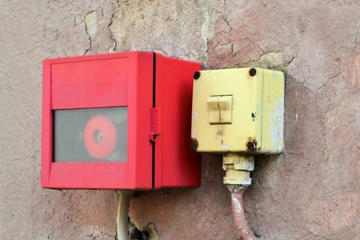 Light switch and alarm button on a façade