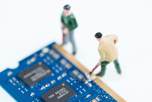 Miniature workmen working on the computer RAM or Random Access Memory component top view close-up