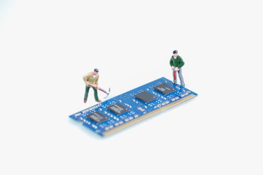 Miniature workmen working on the computer RAM or Random Access Memory component over white background