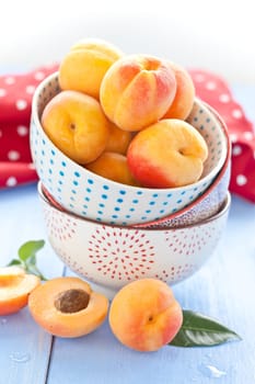 Fresh ripe apricots in a dotted Schuessel