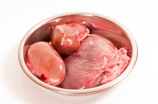 Fresh kidneys and spleen for raw feeding in stainless steel bowl