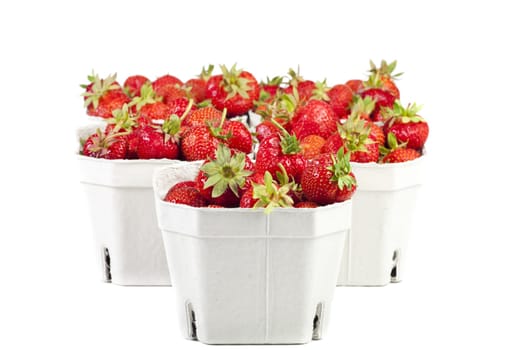 Fresh strawberries from the market in light cardboard boxes on a white background