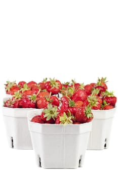 Fresh strawberries from the market in light cardboard boxes on a white background