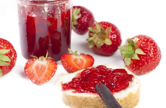 Jam made from freshly harvested strawberries in jars on a white background