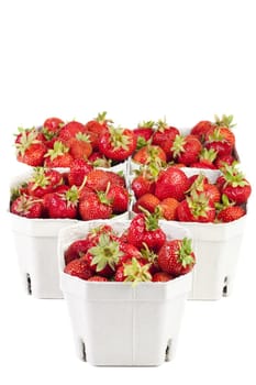 Fresh strawberries from the market in light cardboard boxes on a white background