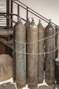 Close-up of steel cylinders with compressed gas - argon, carbon dioxide or oxygen for welding, outdoor, vertical.