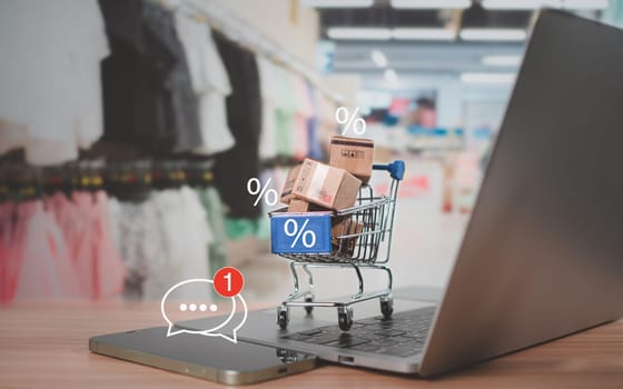 Sale percentage with shopping cart and boxes placed on computer keyboard. Online shopping concept, special price products, Special offers and promotions