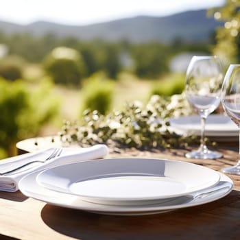 A table with empty plates and wine glasses on it