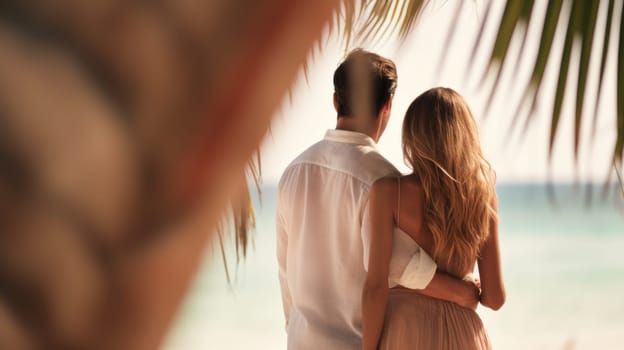 A man and woman standing under palm trees on the beach