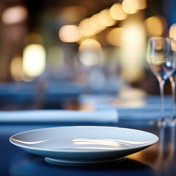 Empty plate on a table with empty wine glasses