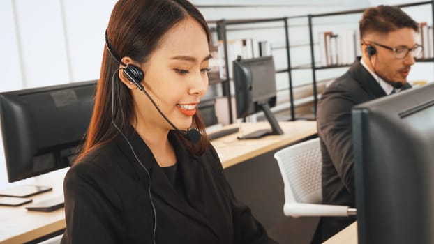 Business people wearing headset working in office to support remote customer or colleague. Call center, telemarketing, customer support agent provide service on telephone video conference call. Jivy