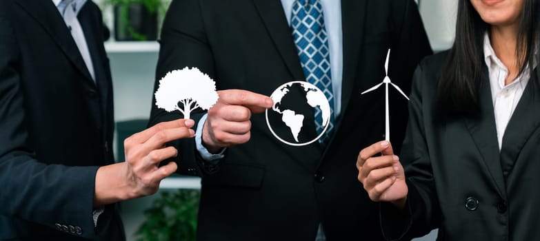 Group of business people holding alternative net zero energy icon for greener sustainable Earth with renewable energy technology to reduce CO2 emission. Quaint