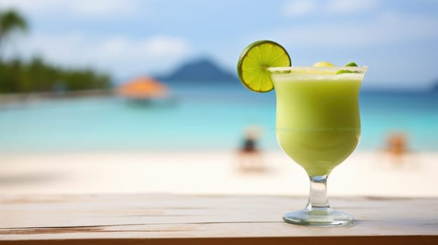A green drink with lime on the beach