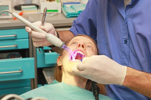 Young bloonde girl in dentist office chair