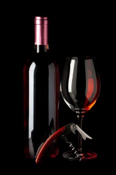Bottle of red wine,a corkscrew and a wine glass insulated against a black background