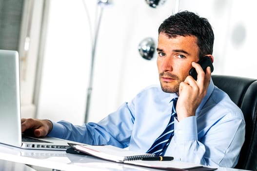 businessman is having a communication with his cellphone