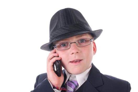 A teenage boy wears a black suit,hat and briefcase and makes phone calls,isolated against a white background.