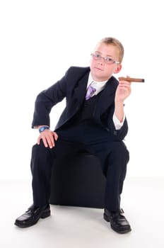 Very young businessman in a dark suit with a thick cigar insulated against a white background.