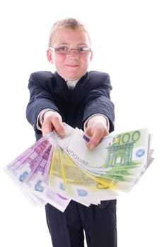 Little boy in a dark suit plays with a bundle of money,isolated against a white background.