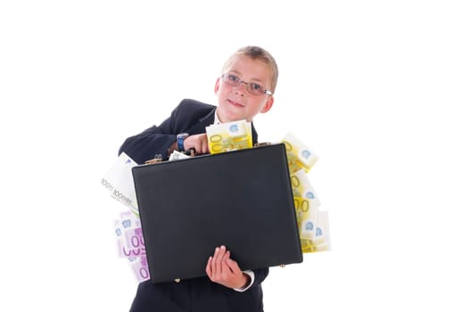 Little boy in a dark suit is out and about with a suitcase full of money,isolated against a white background.
