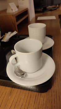 White coffee tea cap hotel apartment wooden table ceramic objects kitchen food drinks . High quality photo