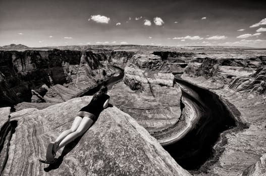 Woman looks over the edge of the abyss at the Grand Canyon,Arizona,USA