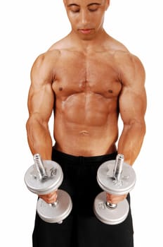 A picture from the front of a young bodybuilder in black shorts lifting.two silver colour dumbbells in his exercises..
