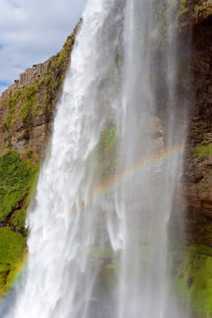 Seljalandsfoss waterfall with rainbow in slanda