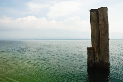 Bollards in the water on Lake Garda near Gargnano