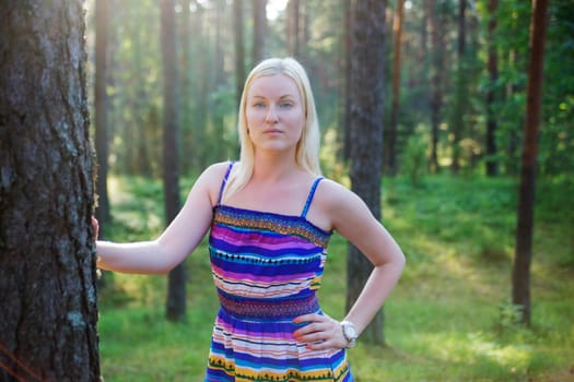 Zoomed woman in lined dress on forest background