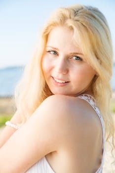 Zoomed portrait of woman in dress smile nicely