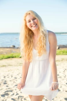 Smiling youthful woman in dress with gold hairs