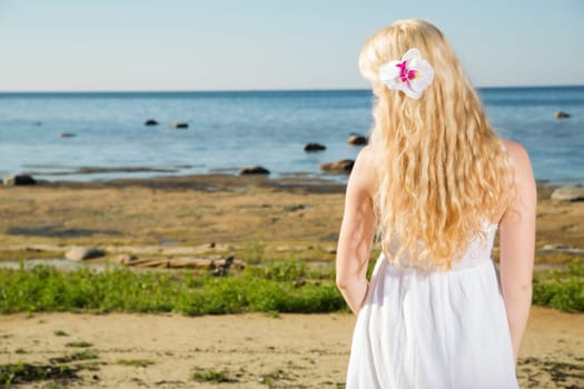 Woman in dress with gold hairs from behind