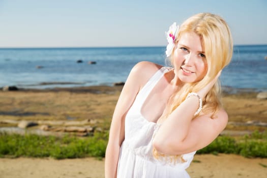 Zoomed woman with white flower in gold hairs