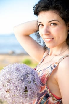 Young woman with dark hairs hold lilac boquet