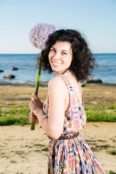 Young woman with dark hairs hold lilac flower