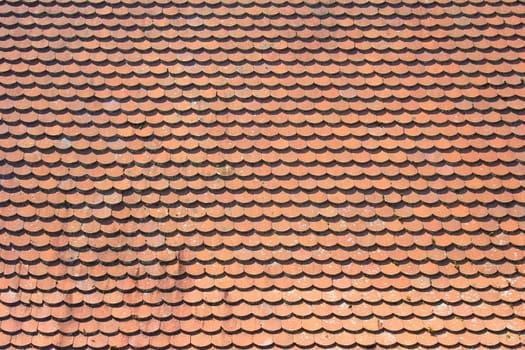 Roof with red roof tiles of the beaver tail type