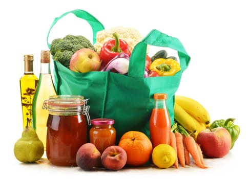 Green shopping bag with grocery products on white background