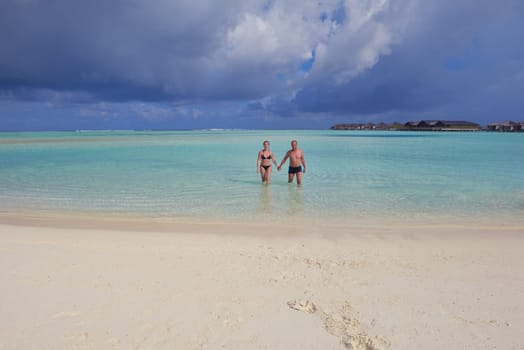happy young  couple at summer vacation have fun and relax at beautiful sunny  day on beach