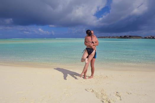 happy young  couple at summer vacation have fun and relax at beautiful sunny  day on beach