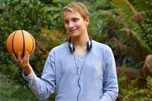 Young man contemplating outdoor basketball sports