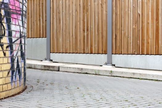The photograph of a noise barrier on a sidewalk.